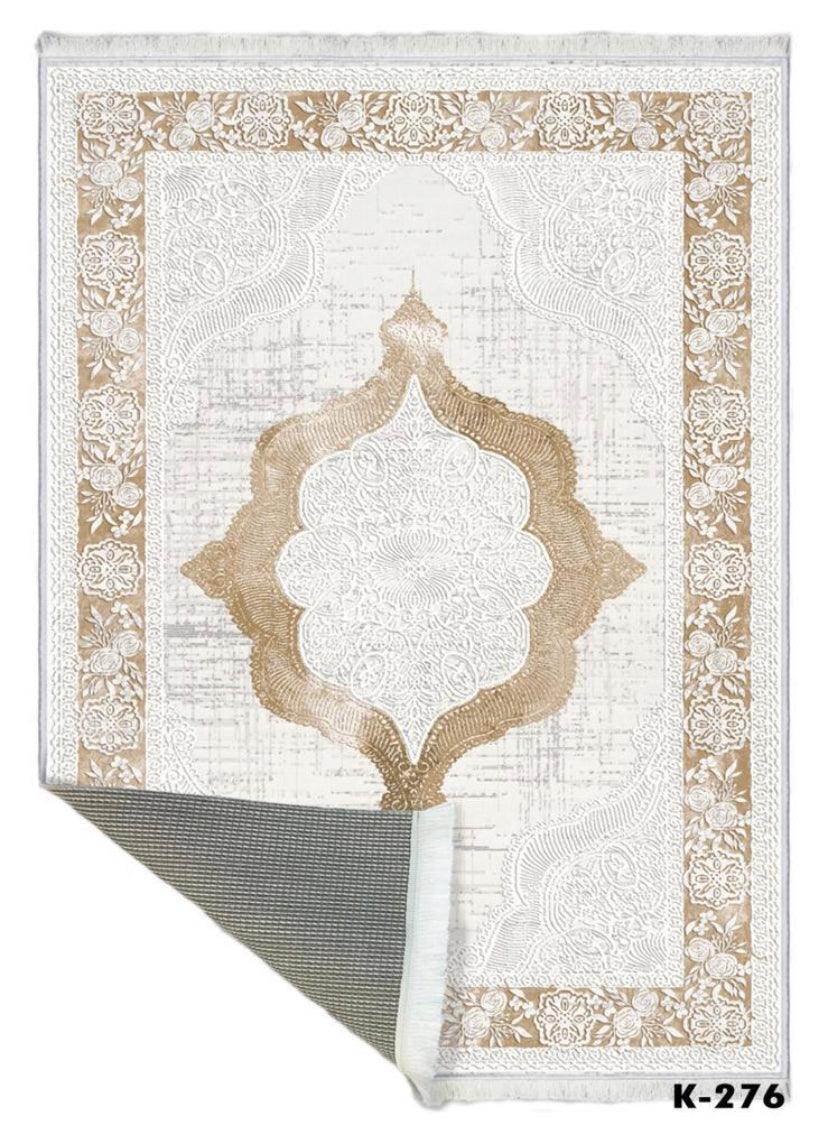 Washable beige and white area rug with floral border and intricate medallion pattern, corner flipped.