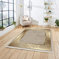 Modern living room with gold accented washable rug on light wood floor, beige armchair, and houseplants.