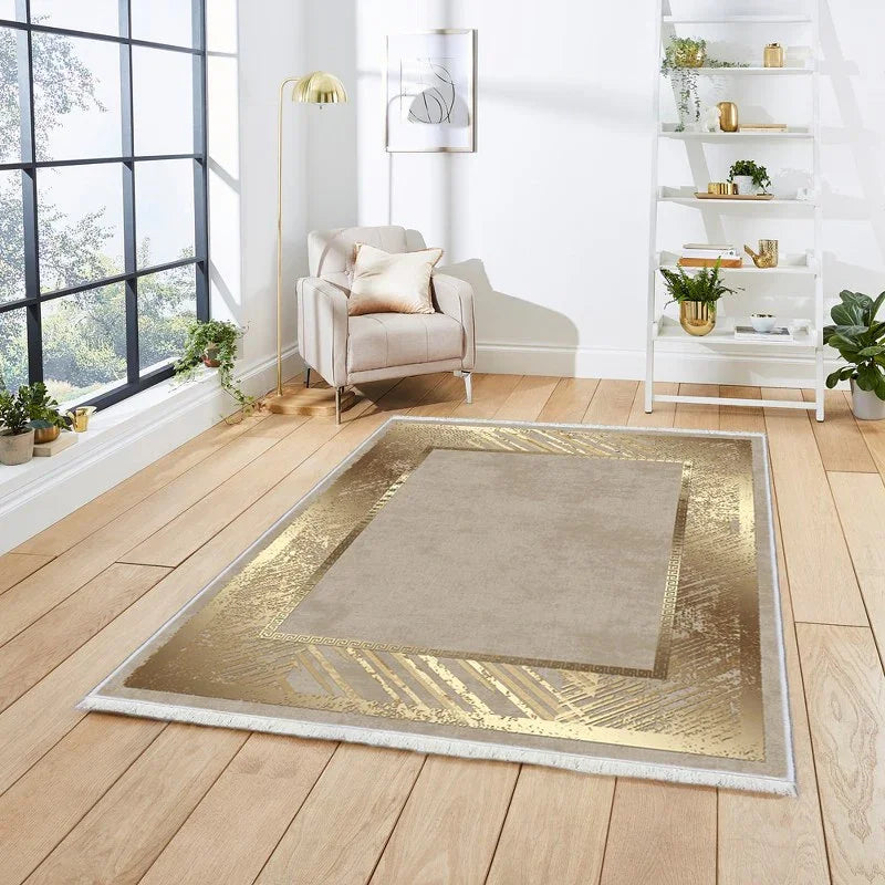 Modern living room with gold accented washable rug on light wood floor, beige armchair, and houseplants.