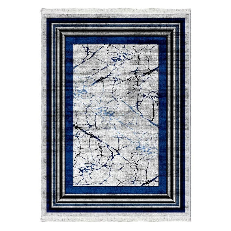 Modern washable rug with blue and black marble pattern and geometric border