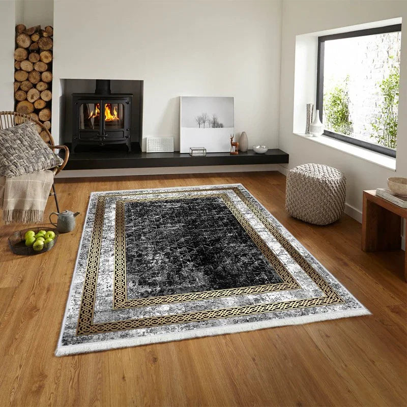 Modern living room with a black and gold patterned washable area rug on wooden floor.