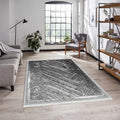 Modern washable rug with black and white geometric pattern in a bright living room