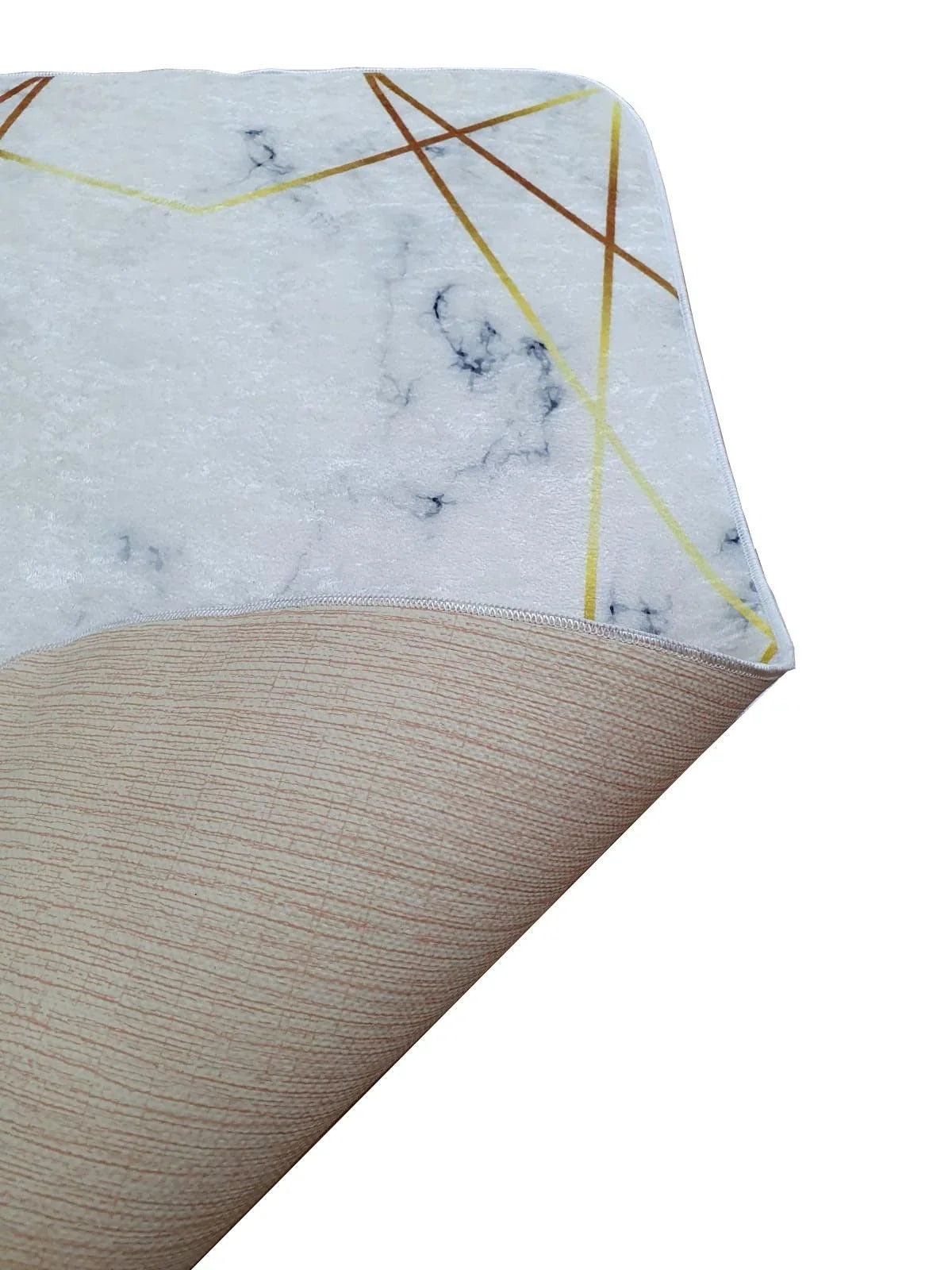 Washable rug with marble pattern and geometric gold lines, corner turned to show backing